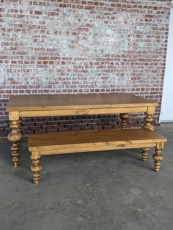 Wooden table and bench with turned legs.