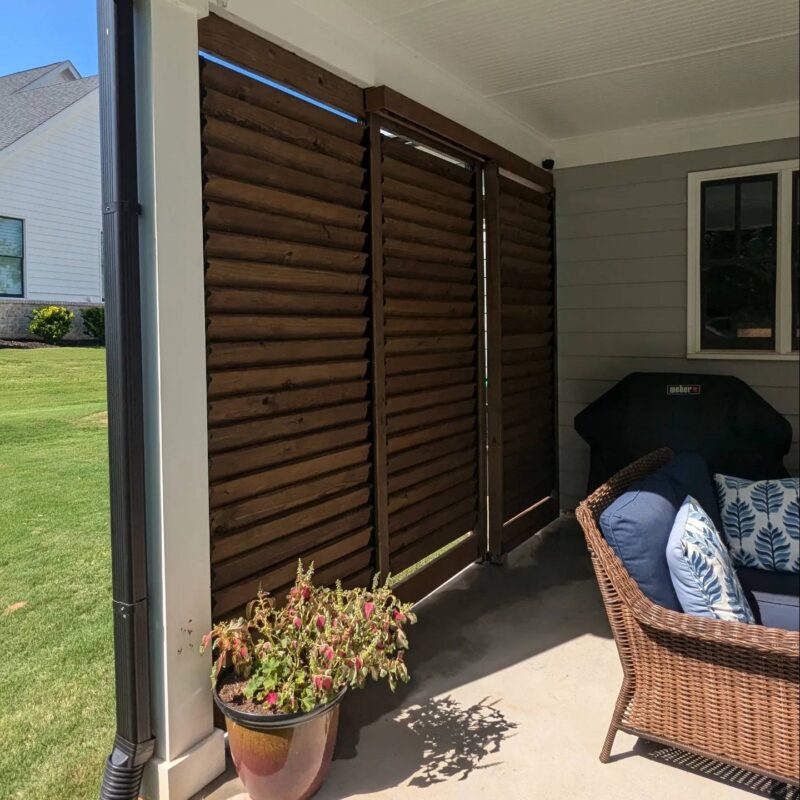 Wooden slat privacy fence on a patio.