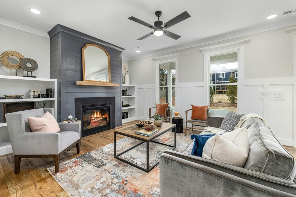 Living room with fireplace and large windows.