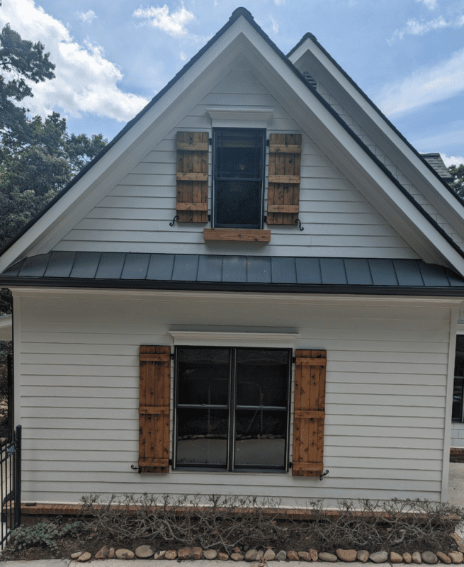 White house with brown shutters and windows.