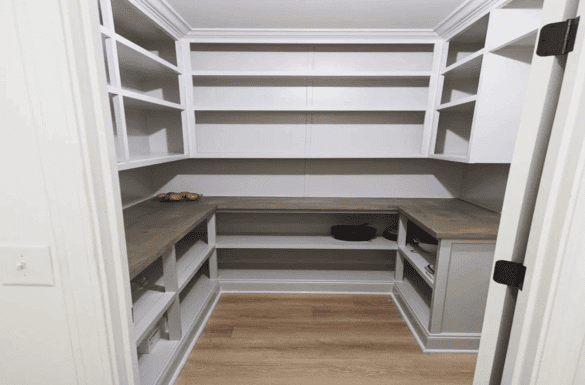 White pantry shelves with wood countertop.