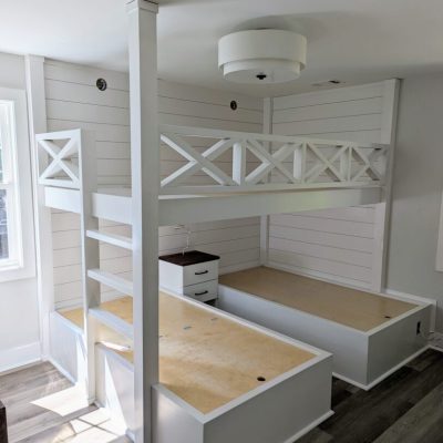 White bunk bed with storage drawers.