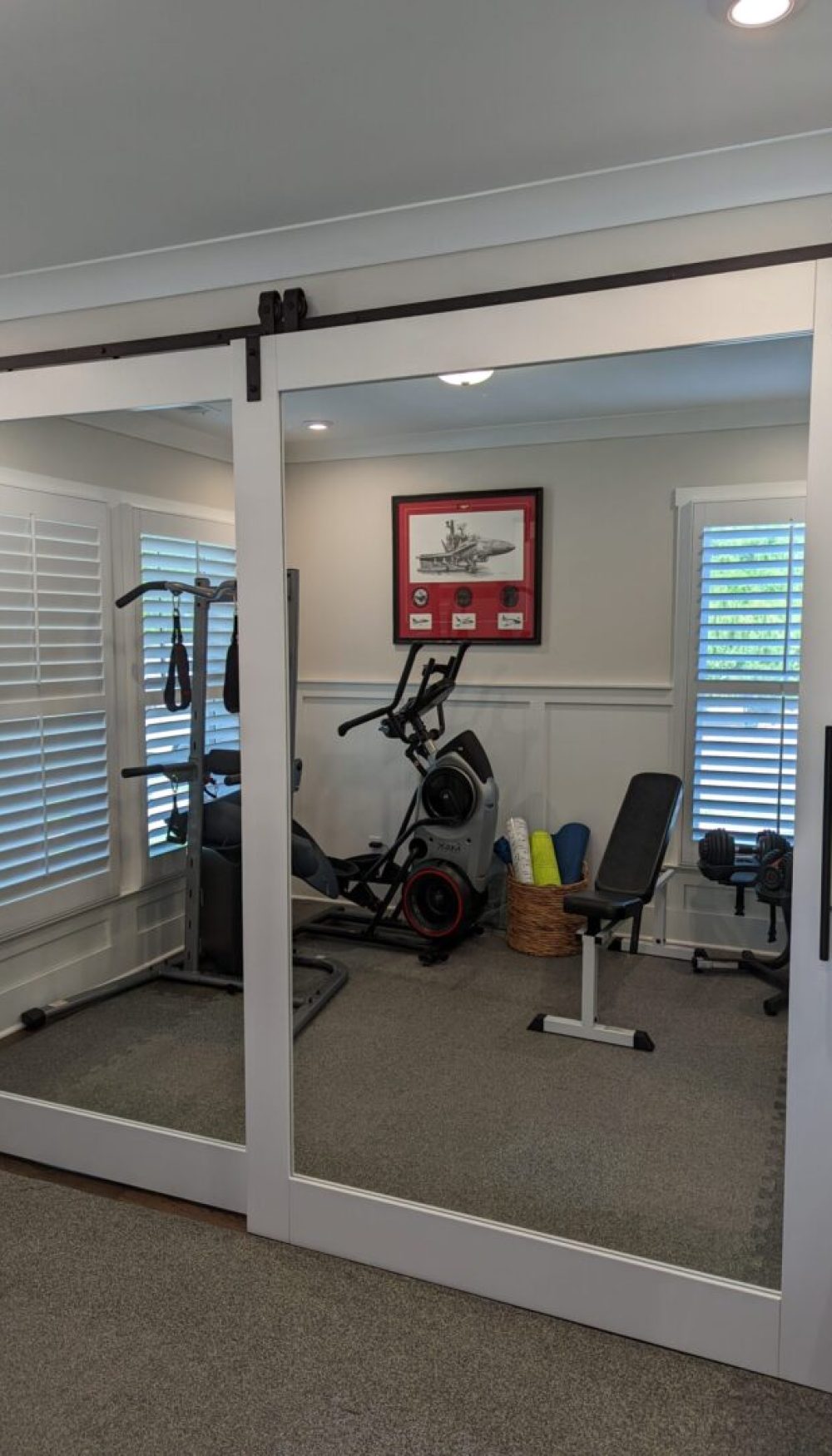 Mirrored sliding doors in home gym.