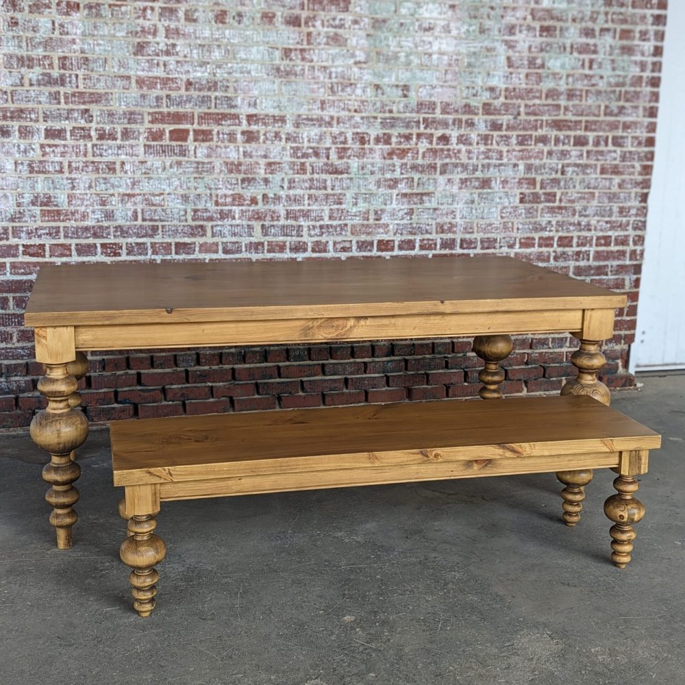 Wooden table and bench with turned legs.